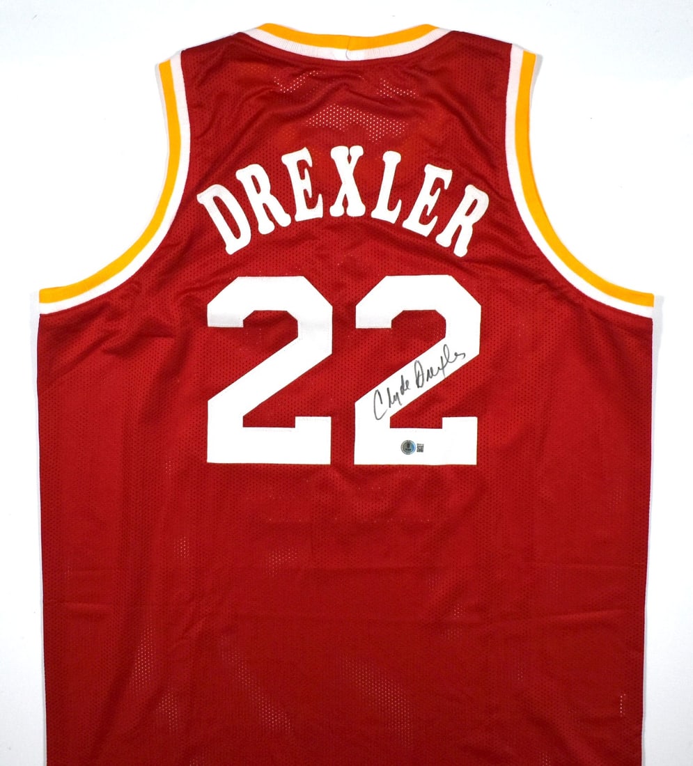 Clyde Drexler Signed Houston Rockets Red Pro Style Jersey Beckett Hologram: Clyde Drexler Signed Houston Rockets Red Pro Style Jersey Beckett Hologram This is a red pro style jersey autographed by Clyde Drexler. The jersey represents the Houston Rockets and is an original ite