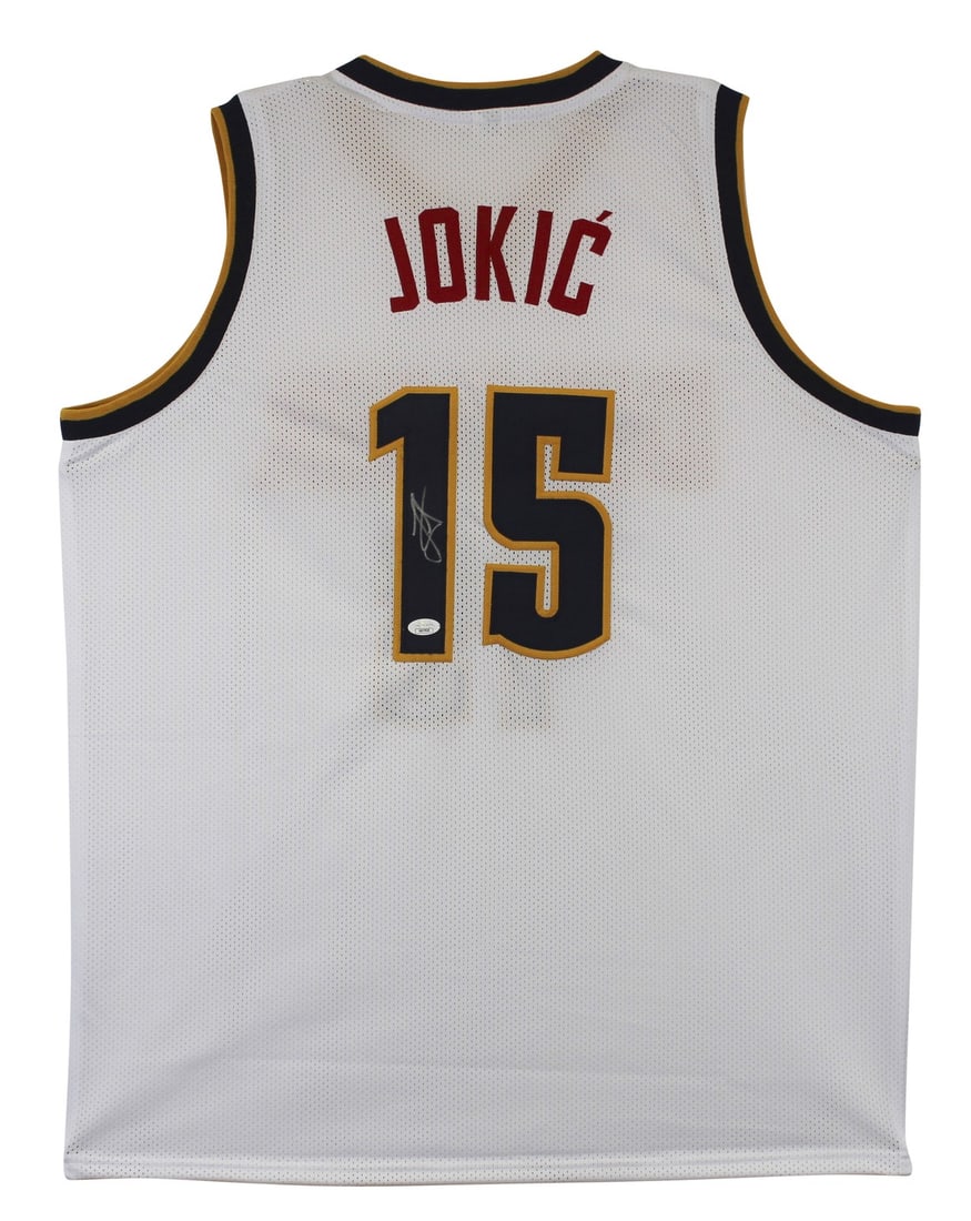 Nikola Jokic Signed Denver Nuggets White Jersey with JSA COA: Nikola Jokic Signed Denver Nuggets White Jersey with JSA COA This authentic autographed white pro style jersey features the signature of Nikola Jokic, the star player for the Denver Nuggets. Crafted i