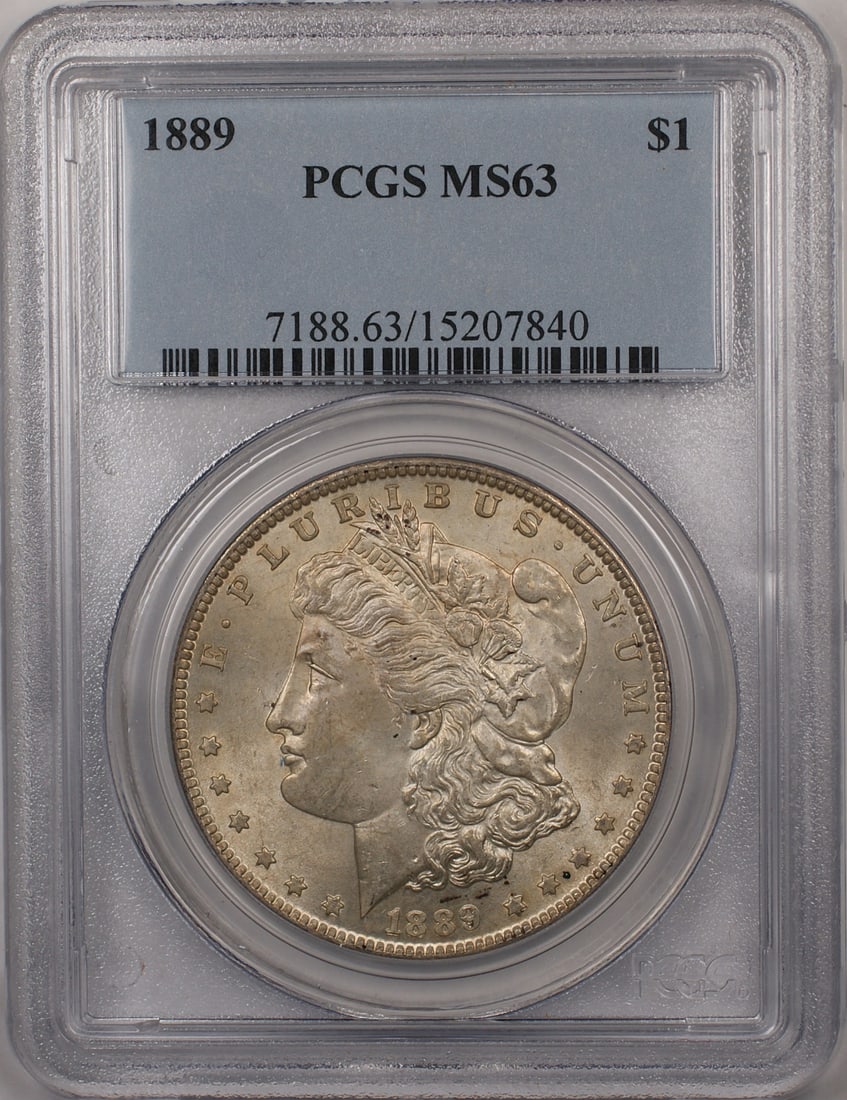 1889 Morgan Dollar PCGS MS63 Silver Coin: 1889 Morgan Dollar PCGS MS63 Silver Coin This 1889 Morgan Silver Dollar is a $1 coin from the United States, graded MS-63 by PCGS. It features light toning and is composed of silver. The coin is uncir