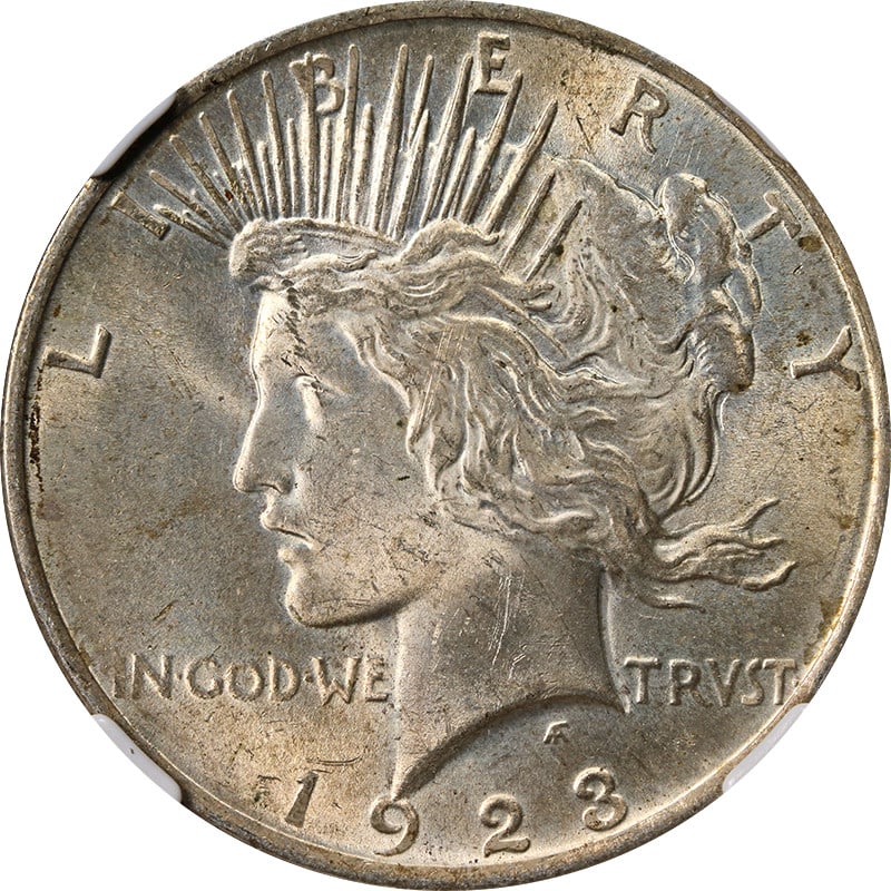 1923 Peace Dollar Silver Coin NGC MS63 With Toned Surfaces: 1923 Peace Dollar Silver Coin NGC MS63 With Toned Surfaces This 1923-P Peace Dollar is certified by NGC with a grade of MS63. The coin features attractive toning and is composed of silver with a finen