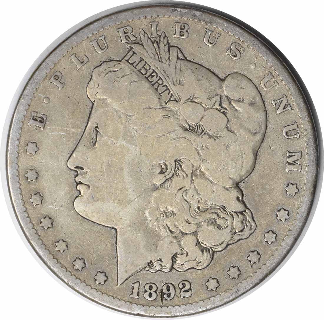 1892-CC Morgan Silver Dollar VG Uncertified 90% Silver Coin: 1892-CC Morgan Silver Dollar VG Uncertified 90% Silver Coin This 1892-CC Morgan Silver Dollar is a remarkable piece of history, featuring the classic design by George T. Morgan. The coin is made of 90