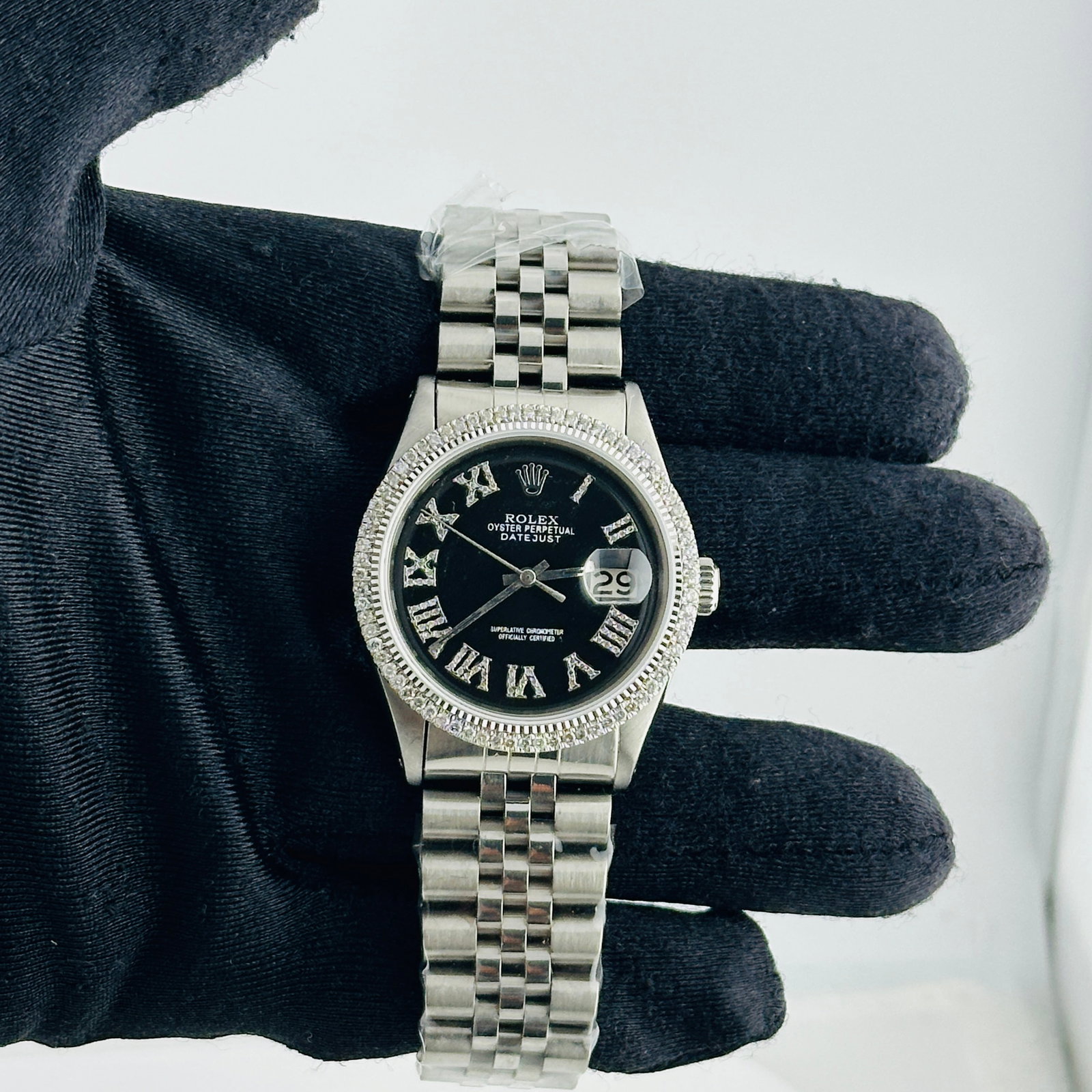 Rolex Datejust aftermarket black Roman diamond dial Jubilee bracelet Ref 1601: Rolex Datejust aftermarket black Roman diamond dial Jubilee bracelet Ref 1601 This Rolex Datejust features an aftermarket black dial adorned with Roman numerals and diamond accents, complemented by an