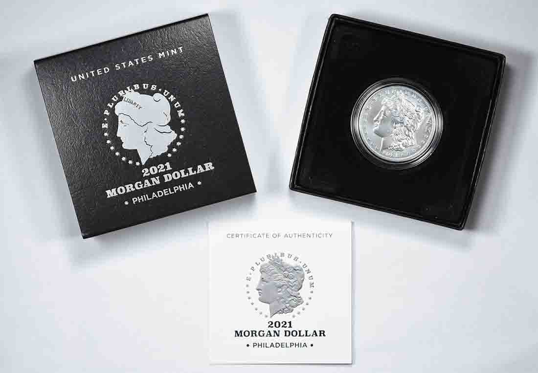 2021 Morgan Dollar Silver in Government Packaging: 2021 Morgan Dollar Silver in Government Packaging This 2021 Morgan Silver Dollar is an uncirculated coin composed of 99.9% silver, struck at the Philadelphia Mint with no mint mark. It comes in its or