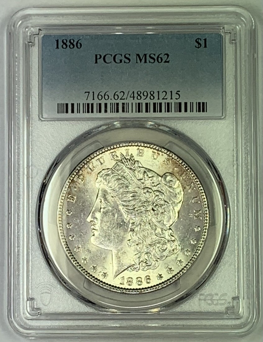 PCGS MS62 1886 Morgan Silver Dollar Uncirculated Certified Coin: PCGS MS62 1886 Morgan Silver Dollar Uncirculated Certified Coin This 1886 Morgan Silver Dollar is graded MS 62 by PCGS and remains uncirculated. Composed of silver, this coin is a classic collectible 