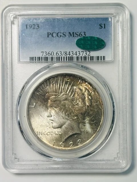 1923 Peace Silver Dollar PCGS MS63 CAC: 1923 Peace Silver Dollar PCGS MS63 CAC This 1923 Peace Dollar is graded MS-63 by PCGS and features CAC approval, indicating quality within its grade. The coin is composed of silver, was minted in Phil