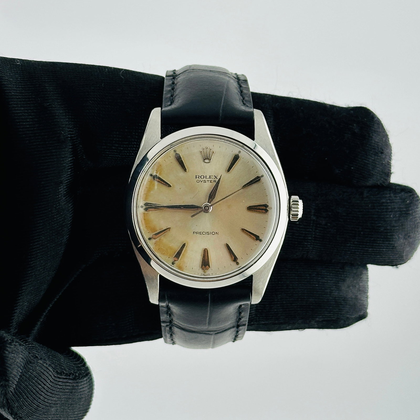 Rolex Oyster Precision Ref 6424 Silver Stick Dial Watch on Aftermarket Leather Strap: Rolex Oyster Precision Ref 6424 Silver Stick Dial Watch on Aftermarket Leather Strap This is a men's Rolex Oyster Precision wristwatch, featuring a silver stick dial and a smooth bezel. The watch is p