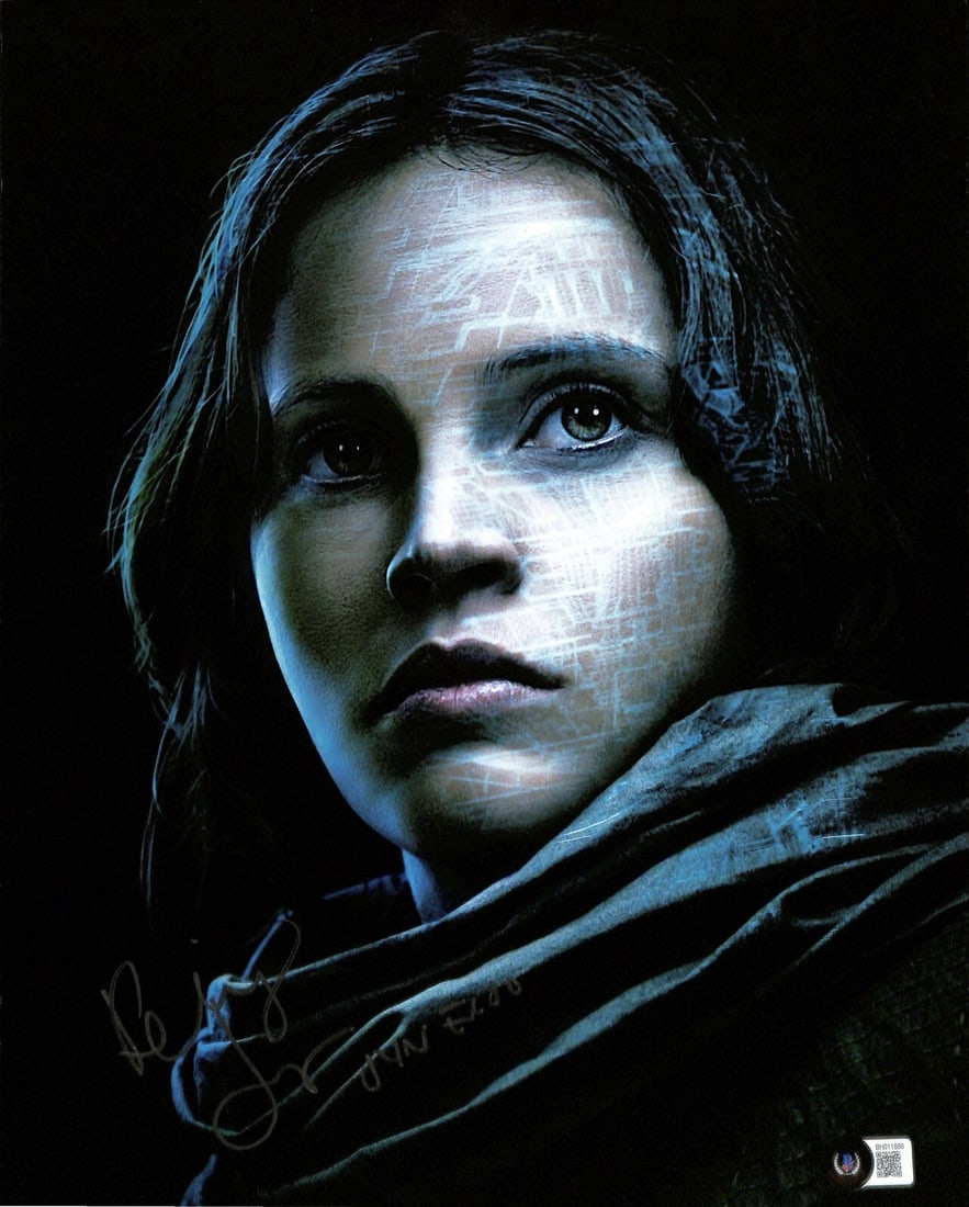 11x14 Signed Photo of Felicity Jones as Jyn Erso with Beckett Authentication: 11x14 Signed Photo of Felicity Jones as Jyn Erso with Beckett Authentication This is an 11x14 color photograph autographed in silver permanent marker by Felicity Jones, who portrayed Jyn Erso in Star 