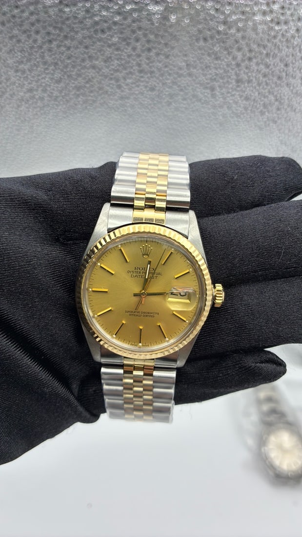 Rolex Datejust 16013 Champagne Stick Dial Aftermarket Jubilee Bracelet: Rolex Datejust 16013 Champagne Stick Dial Aftermarket Jubilee Bracelet This Rolex Datejust features a champagne stick dial and a fluted bezel, paired with an aftermarket Jubilee bracelet. The watch is