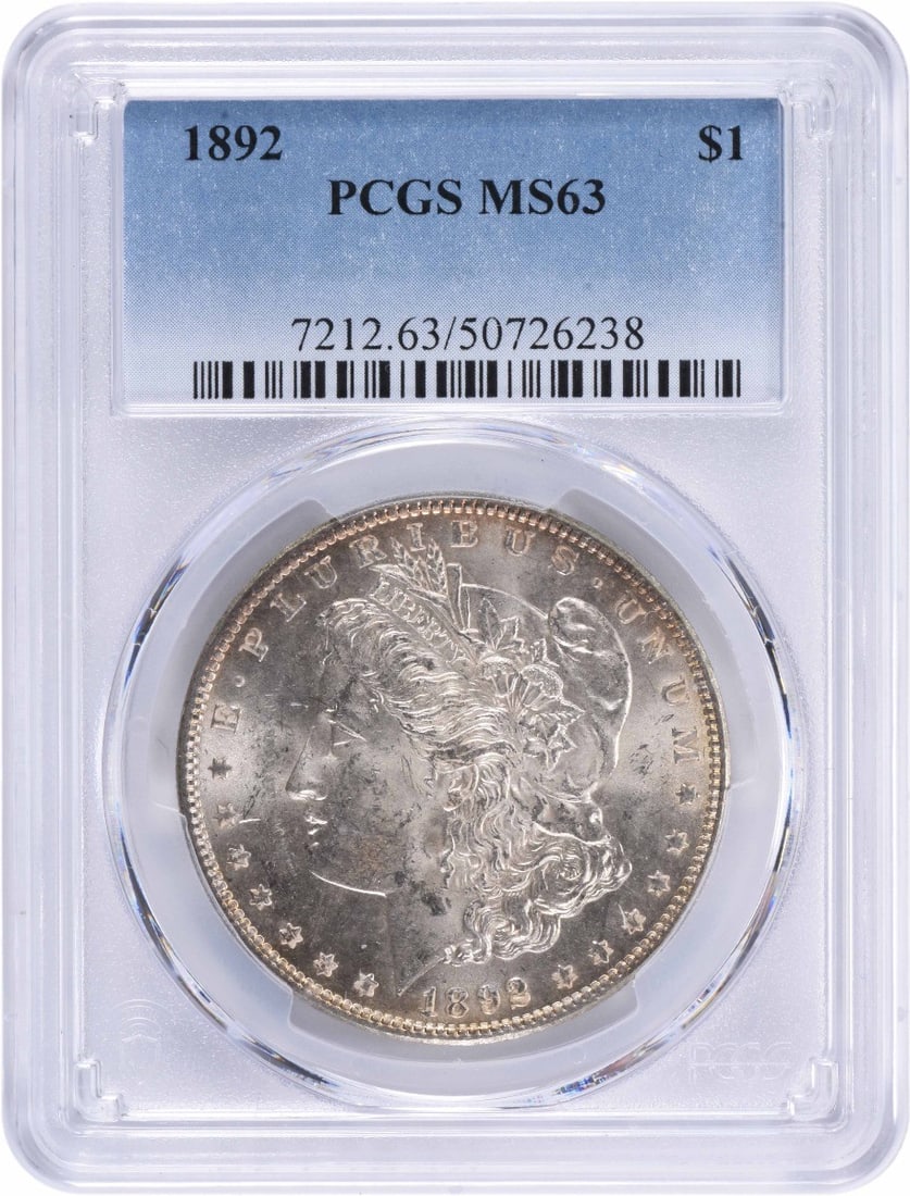 1892 Morgan Silver Dollar MS63 PCGS 90% Silver Uncirculated: 1892 Morgan Silver Dollar MS63 PCGS 90% Silver Uncirculated This 1892 Morgan Silver Dollar is graded MS63 by PCGS, indicating it is in uncirculated condition. Minted in Philadelphia, this coin feature