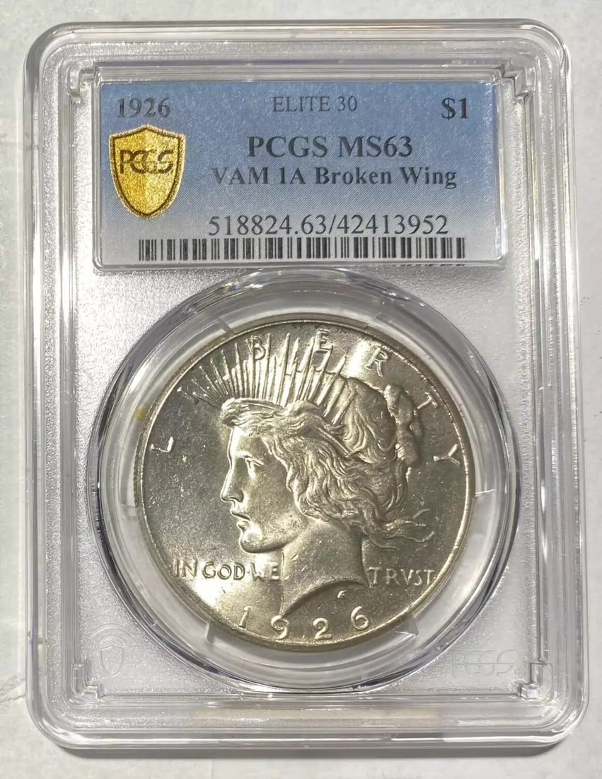 1926 Peace Silver Dollar VAM 1A Broken Wing PCGS MS 63: 1926 Peace Silver Dollar VAM 1A Broken Wing PCGS MS 63 This 1926 Peace Silver Dollar, certified by PCGS with a grade of MS-63, showcases a beautiful representation of American coinage. Known for its d