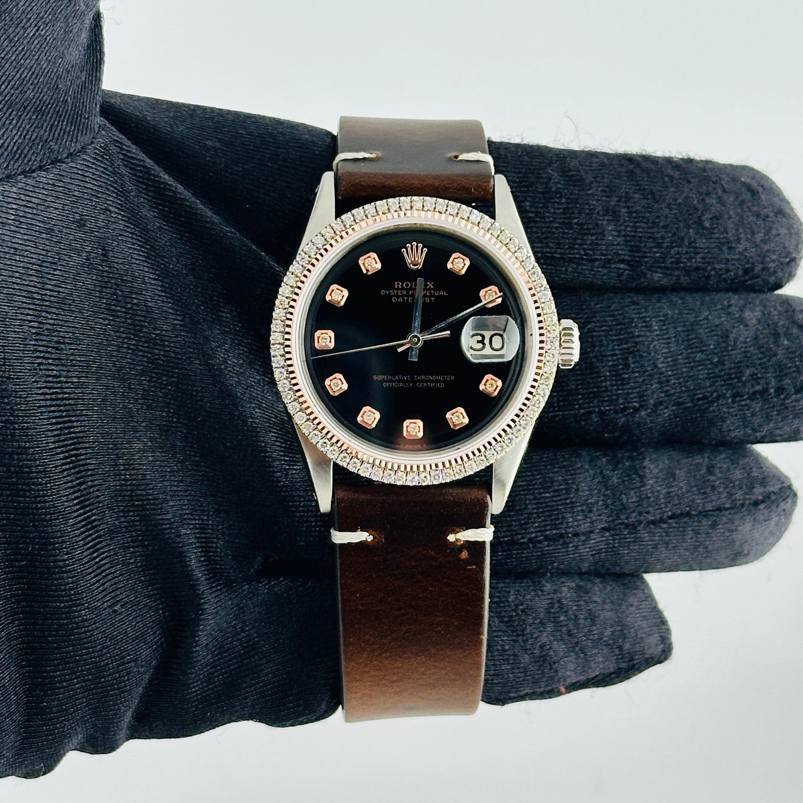 Rolex Datejust Ref 1601 Black Rose Diamond Dial Watch with Aftermarket Leather Strap: Rolex Datejust Ref 1601 Black Rose Diamond Dial Watch with Aftermarket Leather Strap This Rolex Datejust features an aftermarket black dial with rose diamond hour markers, set within a prong rose gold