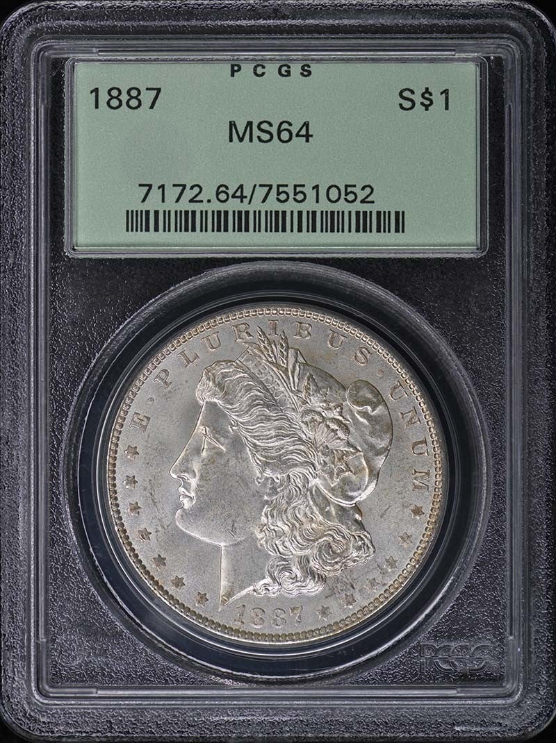 1887 Morgan Dollar PCGS MS64 OGH: 1887 Morgan Dollar PCGS MS64 OGH This 1887 Morgan Dollar is graded MS64 by PCGS and comes in an Old Green Holder (OGH). Struck at the Philadelphia Mint, this uncirculated coin is a pre-owned collectib