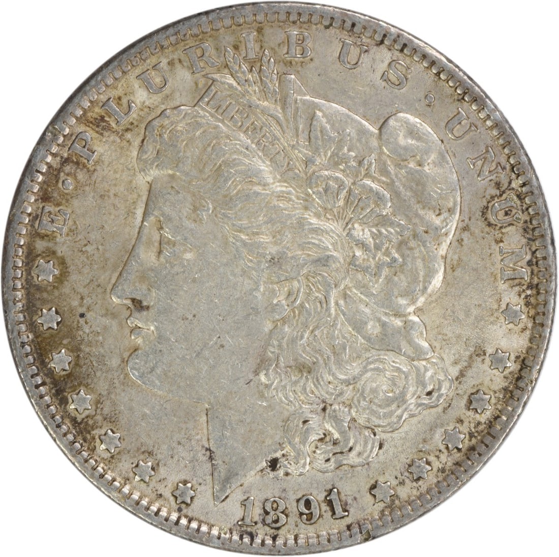 1891 Morgan Silver Dollar AU Uncertified 90% Silver Coin: 1891 Morgan Silver Dollar AU Uncertified 90% Silver Coin This 1891 Morgan Silver Dollar is a remarkable piece of numismatic history, featuring a stunning design by George T. Morgan. The coin is compos