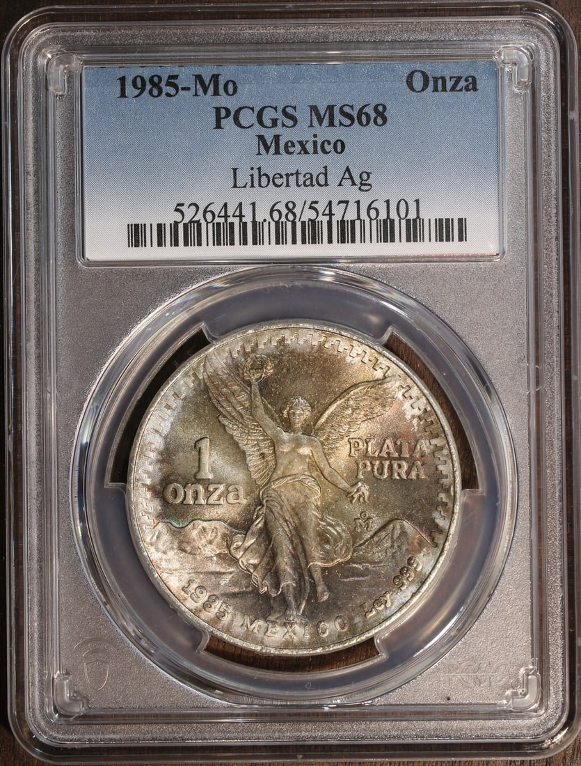 Mexico 1985-Mo Silver Libertad Onza 1 oz MS68 PCGS: Mexico 1985-Mo Silver Libertad Onza 1 oz MS68 PCGS 1985 Mexico 1 oz Silver Libertad Onza, graded MS 68 by PCGS. The coin is composed of 0.999 fine silver and was minted by the Mexican Mint. It is pre-