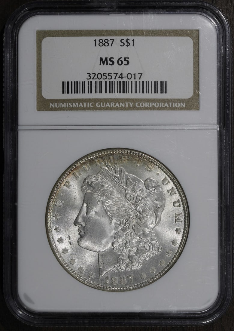NGC MS65 1887 Morgan Silver Dollar $1 Gem: NGC MS65 1887 Morgan Silver Dollar $1 Gem 1887 Morgan Silver Dollar graded MS65 by Numismatic Guaranty Company (NGC). This pre-owned United States coin has a $1 denomination, silver composition, and 0
