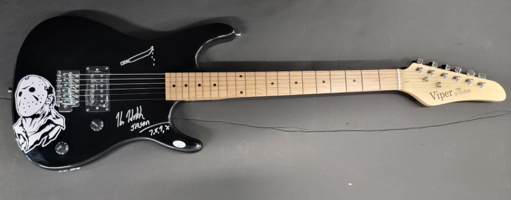 Kane Hodder Autographed Electric Guitar JSA Certified: Kane Hodder Autographed Electric Guitar JSA Certified This is an authentic electric guitar signed by Kane Hodder, a notable figure in the horror film industry. The autograph has been verified by James