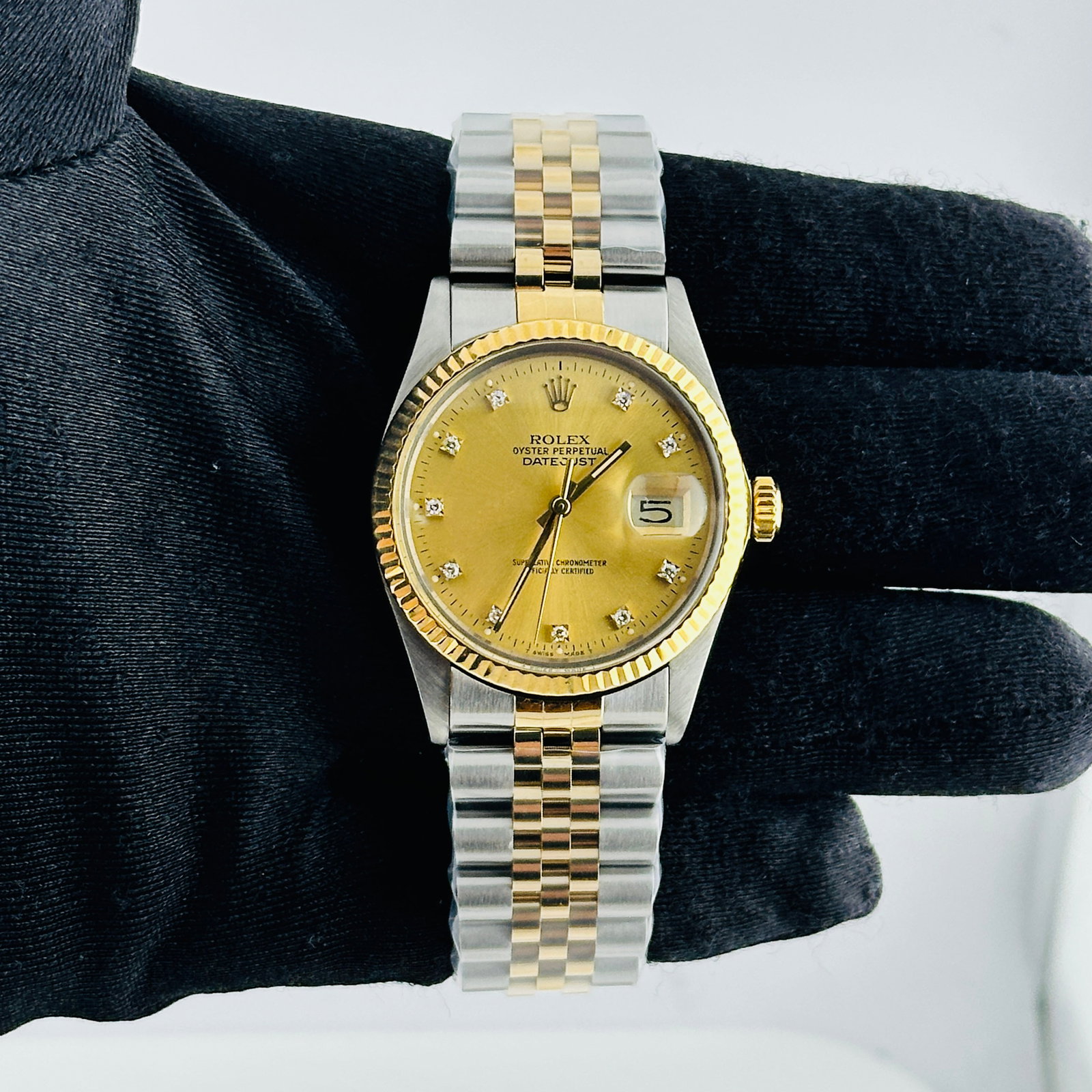 Rolex Datejust Ref 16013G Champagne Diamond Dial on Aftermarket Jubilee Bracelet: Rolex Datejust Ref 16013G Champagne Diamond Dial on Aftermarket Jubilee Bracelet This Rolex Datejust features a champagne diamond factory dial and a fluted bezel, paired with an aftermarket Jubilee br