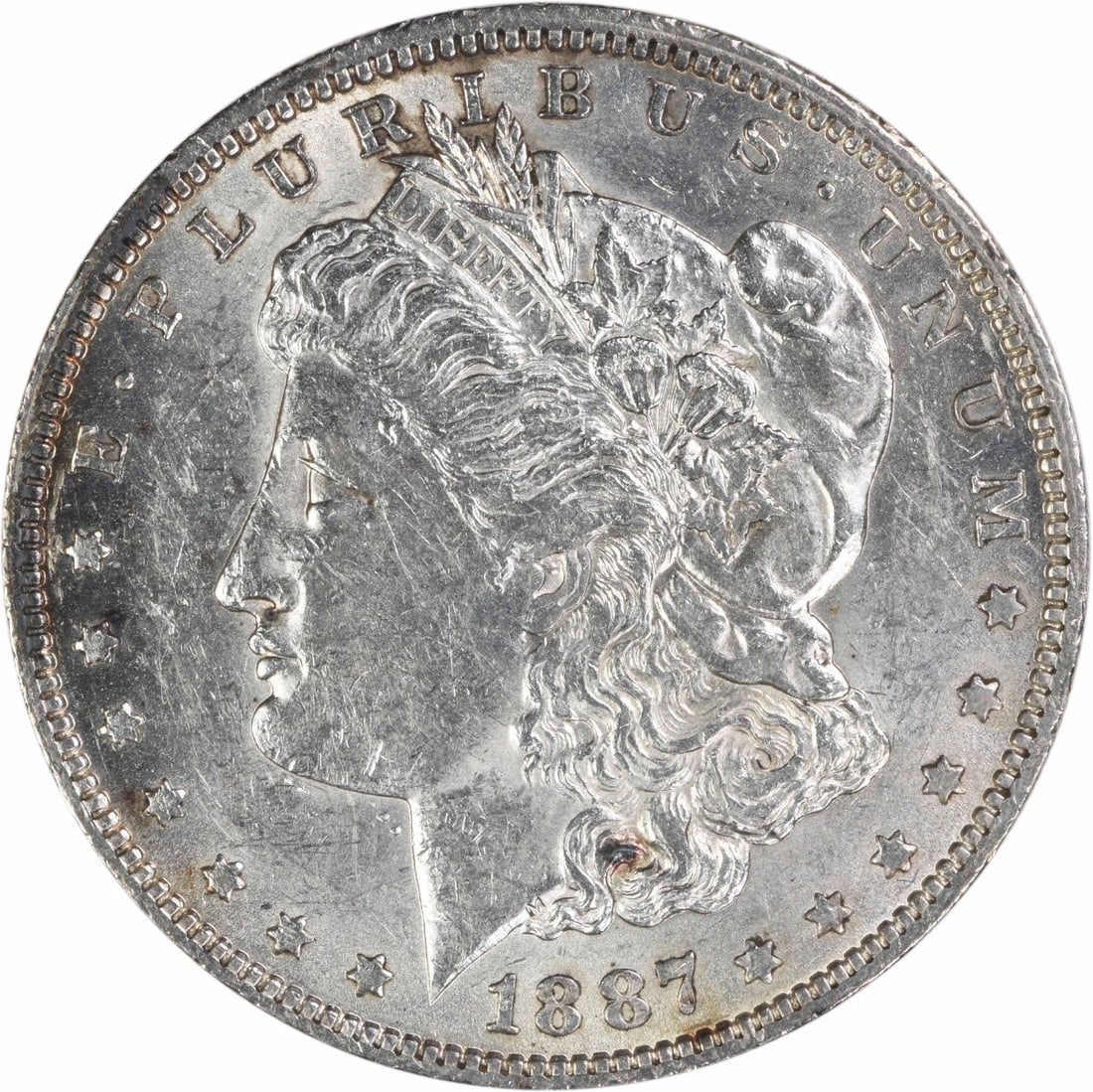 AU Grade 1887 New Orleans Morgan Dollar Uncertified US Silver Coin: AU Grade 1887 New Orleans Morgan Dollar Uncertified US Silver Coin This 1887-O Morgan Silver Dollar is an uncertified, circulated coin featuring the iconic design by George T. Morgan. The coin was min