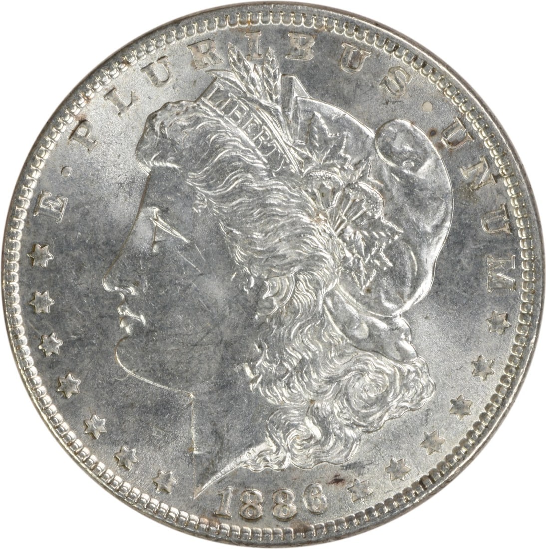 Choice BU 1886 Silver Morgan Dollar Uncertified Philadelphia Mint: Choice BU 1886 Silver Morgan Dollar Uncertified Philadelphia Mint This is an 1886 Morgan Silver Dollar from the United States. The coin is uncirculated and composed of silver. It is graded as Choice B
