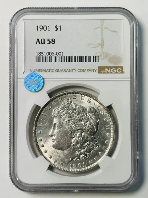 NGC AU-58 1901 Morgan Silver Dollar Sight White: NGC AU-58 1901 Morgan Silver Dollar Sight White 1901 Morgan Silver Dollar certified by NGC and graded AU 58. This pre-owned coin is composed of silver and has a Sight White appearance. It is a 1901 do