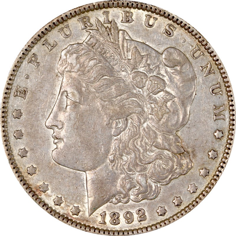 United States 1892 P Morgan Silver Dollar Coin: United States 1892 P Morgan Silver Dollar Coin 1892-P Morgan Silver Dollar in circulated condition. The coin is composed of silver with a fineness of 0.9 and was minted in the United States. It is lis