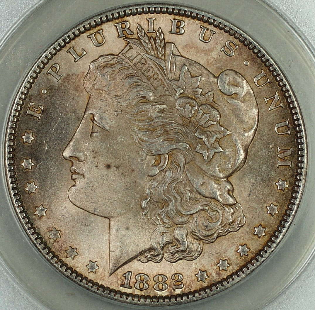 1882 Silver Morgan Dollar ANACS MS-63 Toned Uncirculated Philadelphia: 1882 Silver Morgan Dollar ANACS MS-63 Toned Uncirculated Philadelphia This 1882 Morgan Silver Dollar coin is certified by ANACS with a grade of MS-63. The coin is uncirculated and features attractive 