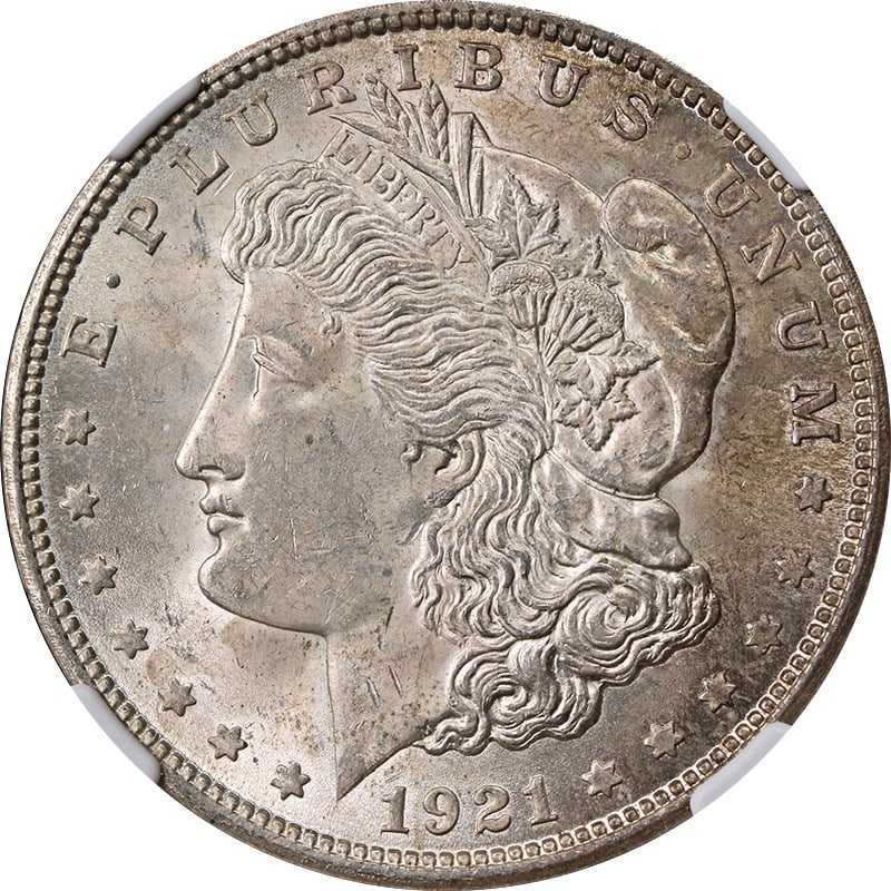 1921 Philadelphia Morgan Dollar Silver NGC MS63 With Toned Surfaces: 1921 Philadelphia Morgan Dollar Silver NGC MS63 With Toned Surfaces This 1921-P Morgan Silver Dollar is certified by NGC with a grade of MS63. Composed of silver with a fineness of 0.9, this uncircula