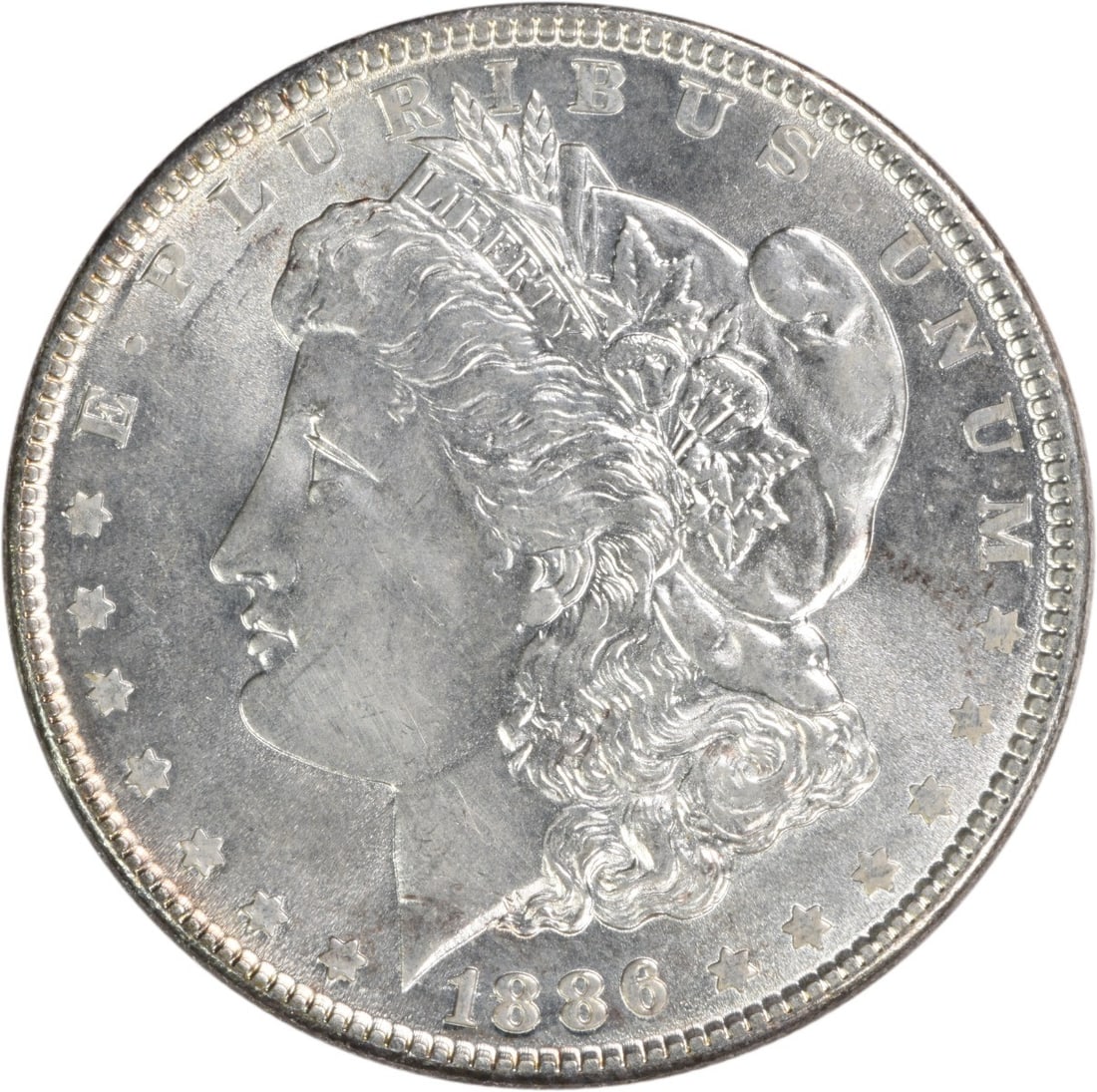 Uncertified 1886 Morgan Dollar Silver Choice BU No Mint Mark: Uncertified 1886 Morgan Dollar Silver Choice BU No Mint Mark This 1886 Morgan Silver Dollar is a Choice Brilliant Uncirculated coin. Composed of silver, it was minted in the United States with no mint