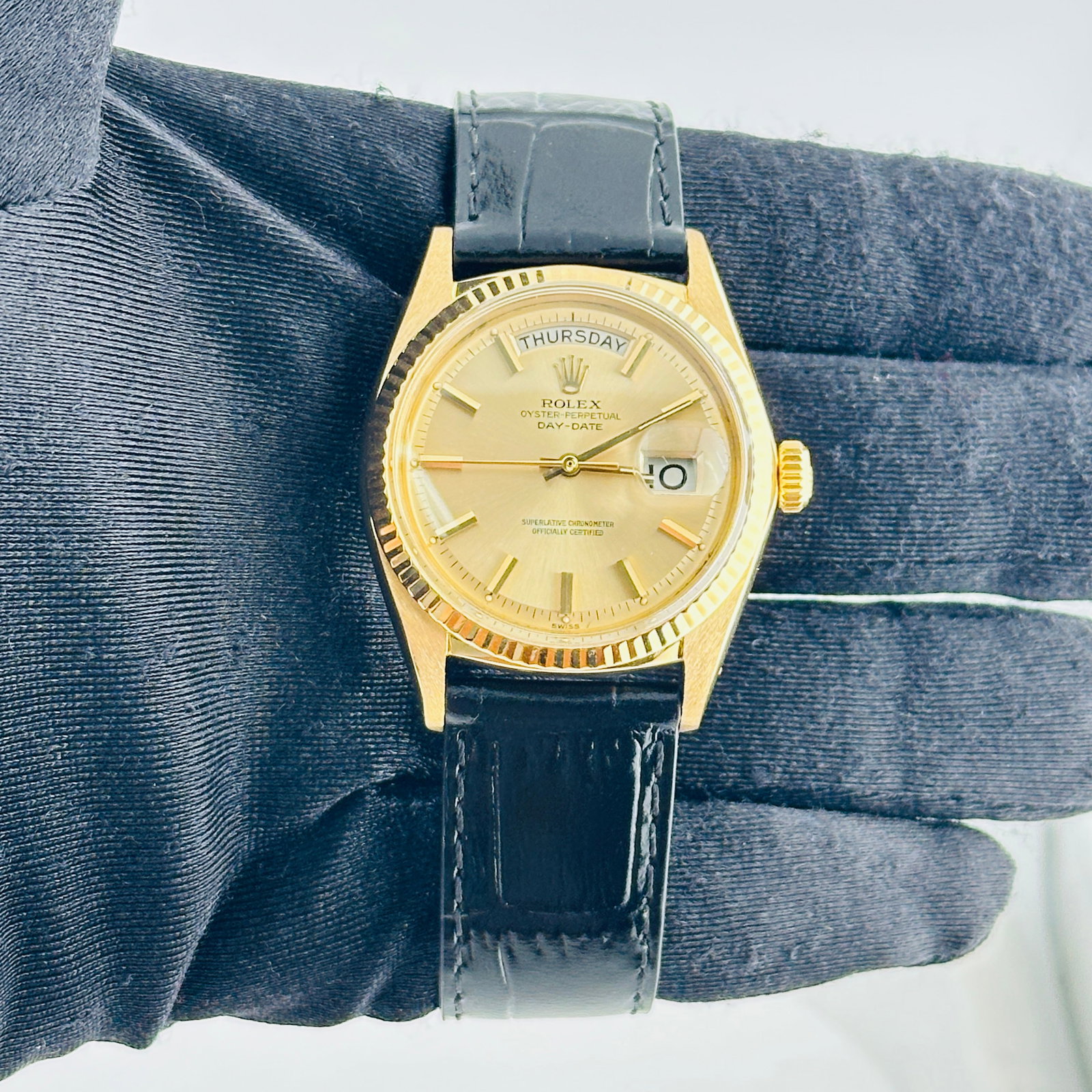 Rolex Ref. 1803 Day-Date Mens Watch Champagne Dial Leather Strap: Rolex Ref. 1803 Day-Date Mens Watch Champagne Dial Leather Strap Mens Rolex Day-Date watch, reference 1803, featuring a champagne stick dial and fluted bezel. It is fitted with a generic leather strap