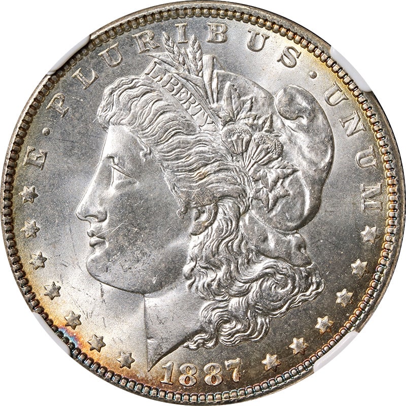 1887-P Morgan Silver Dollar NGC MS66 with Peripheral Toning: 1887-P Morgan Silver Dollar NGC MS66 with Peripheral Toning This stunning 1887-P Morgan Silver Dollar showcases exquisite peripheral toning and is certified by NGC with a remarkable grade of MS66. As 
