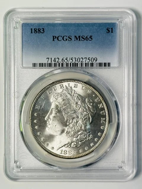 PCGS MS-65 1883 Morgan Silver Dollar Philadelphia Mint: PCGS MS-65 1883 Morgan Silver Dollar Philadelphia Mint 1883 Morgan Silver Dollar graded MS 65 by PCGS. This U.S. dollar coin is composed of silver and was minted in Philadelphia. The coin is pre-owned