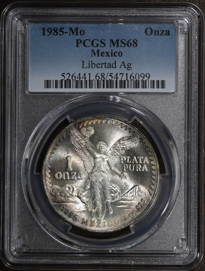 PCGS MS68 1985-Mo Mexico Silver Libertad Onza 1 oz Coin: PCGS MS68 1985-Mo Mexico Silver Libertad Onza 1 oz Coin This 1985 Mexico 1 oz Silver Libertad Onza coin is certified by PCGS and graded MS 68. It is composed of 0.999 fine silver and was minted by the