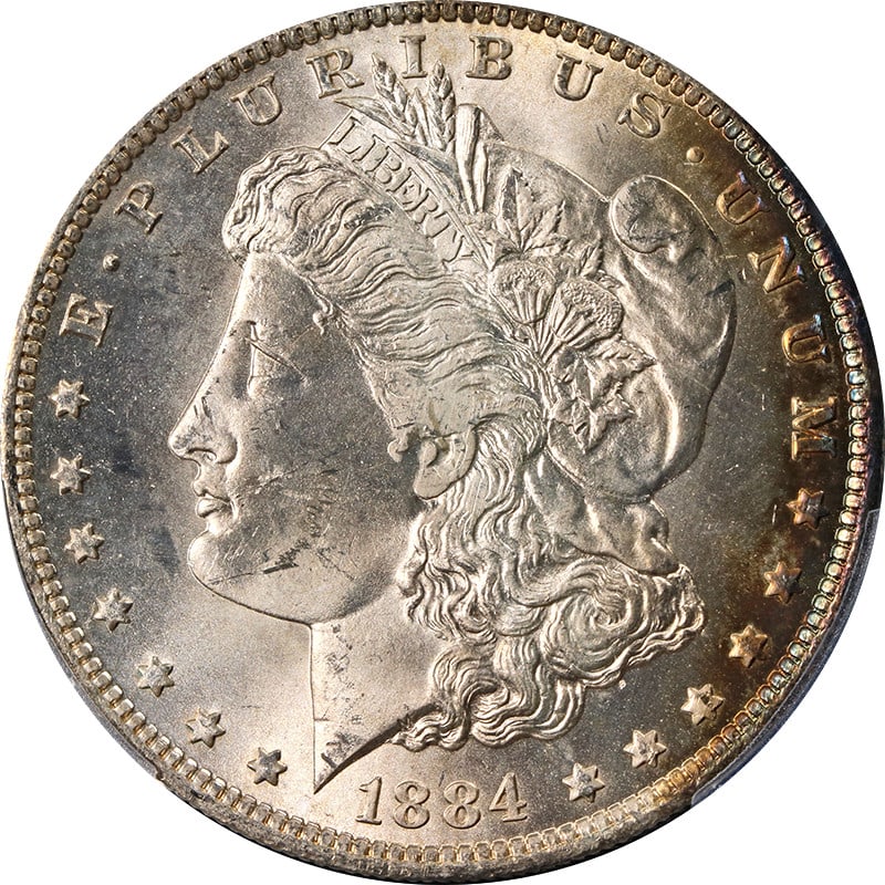 PCGS MS64 1884-O Morgan Dollar with Colorful Toning: PCGS MS64 1884-O Morgan Dollar with Colorful Toning This 1884-O Morgan Silver Dollar features attractive toning and has been graded MS64 by PCGS. The coin is uncirculated and composed of silver, minte