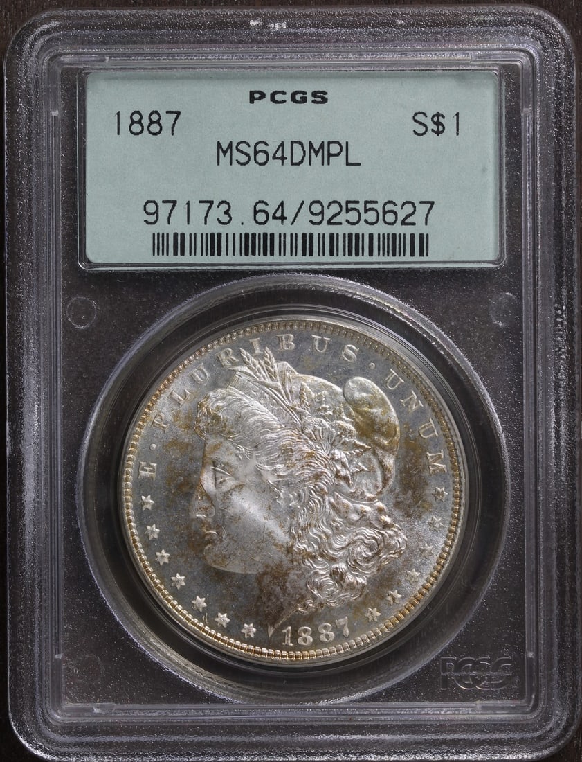 1887 Morgan Dollar MS64DMPL Silver $1 PCGS Old Green Holder: 1887 Morgan Dollar MS64DMPL Silver $1 PCGS Old Green Holder This 1887 Morgan Silver Dollar is graded MS64DMPL and certified by PCGS. Struck in Philadelphia, this uncirculated coin features a proof-lik
