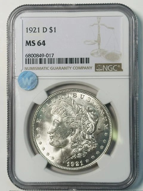 NGC MS 64 1921 D Morgan Silver Dollar Sight White: NGC MS 64 1921 D Morgan Silver Dollar Sight White 1921 D Morgan Silver Dollar certified by NGC and graded MS 64. This pre-owned silver dollar is from 1921, with Denver listed as the mint location and 