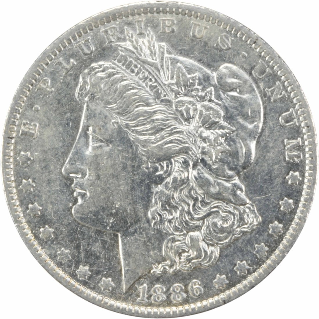 1886-O Morgan Silver Dollar AU Uncertified 90% Silver Coin: 1886-O Morgan Silver Dollar AU Uncertified 90% Silver Coin This 1886-O Morgan Silver Dollar is a beautiful piece of American history, featuring a grade of About Uncirculated (AU). Struck at the New Or