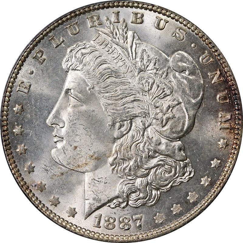 PCGS MS63 1887 P Morgan Silver Dollar Silver Toned: PCGS MS63 1887 P Morgan Silver Dollar Silver Toned 1887-P Morgan Silver Dollar certified by PCGS and graded MS63. The coin is uncirculated, composed of silver with 0.9 fineness, and features toning. I