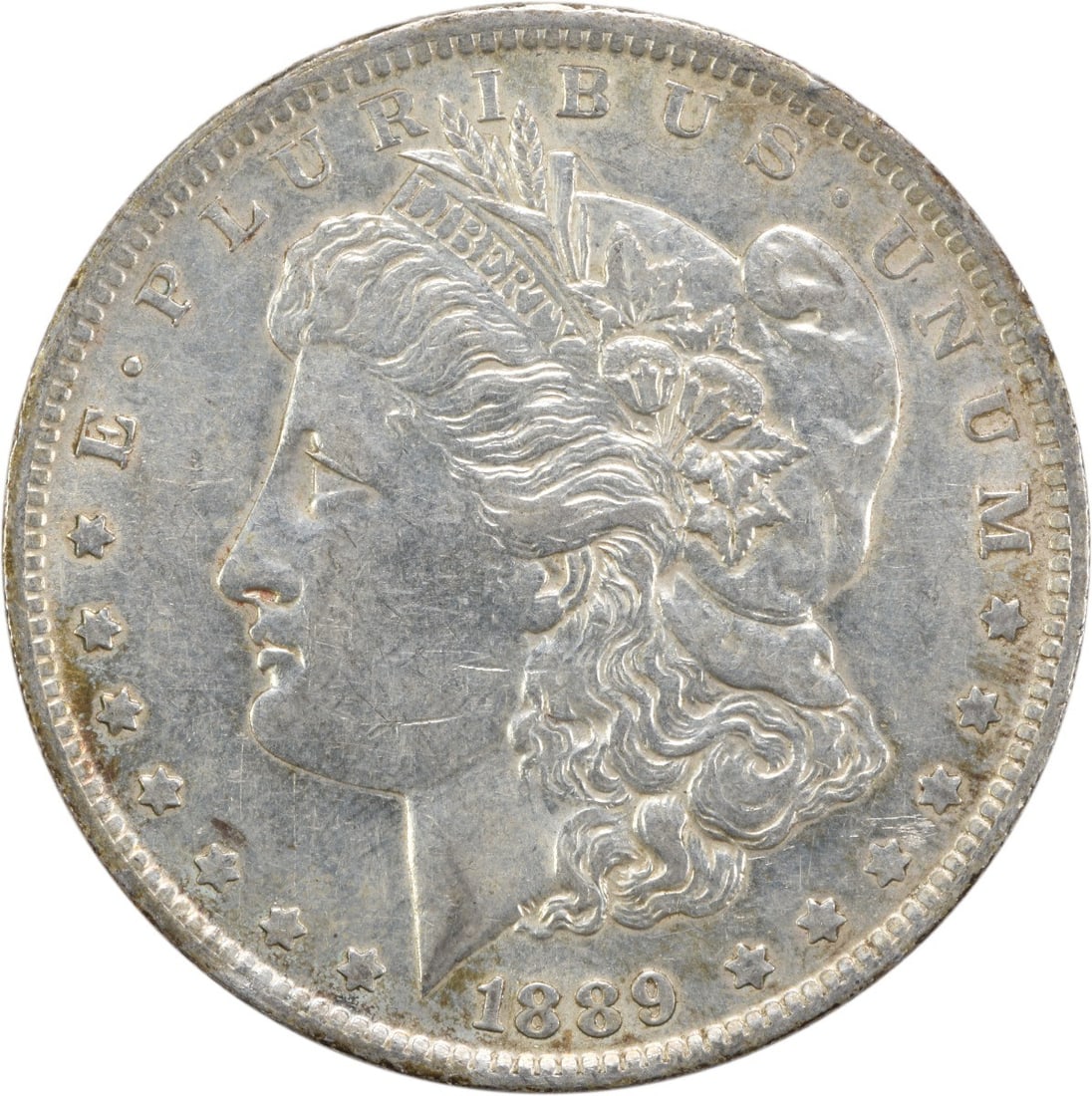 AU Grade 1889 O Morgan Dollar Uncertified 90 Percent Silver Coin: AU Grade 1889 O Morgan Dollar Uncertified 90 Percent Silver Coin This 1889-O Morgan Silver Dollar is an uncertified, circulated coin struck at the New Orleans Mint. Composed of 90% silver and 10% copp