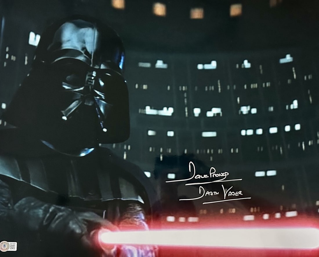 David Prowse Darth Vader Signed 16x20 Photo with Inscription Beckett Certified: David Prowse Darth Vader Signed 16x20 Photo with Inscription Beckett Certified This striking 16x20 color photograph features David Prowse, the actor who famously portrayed Darth Vader, captured in a m