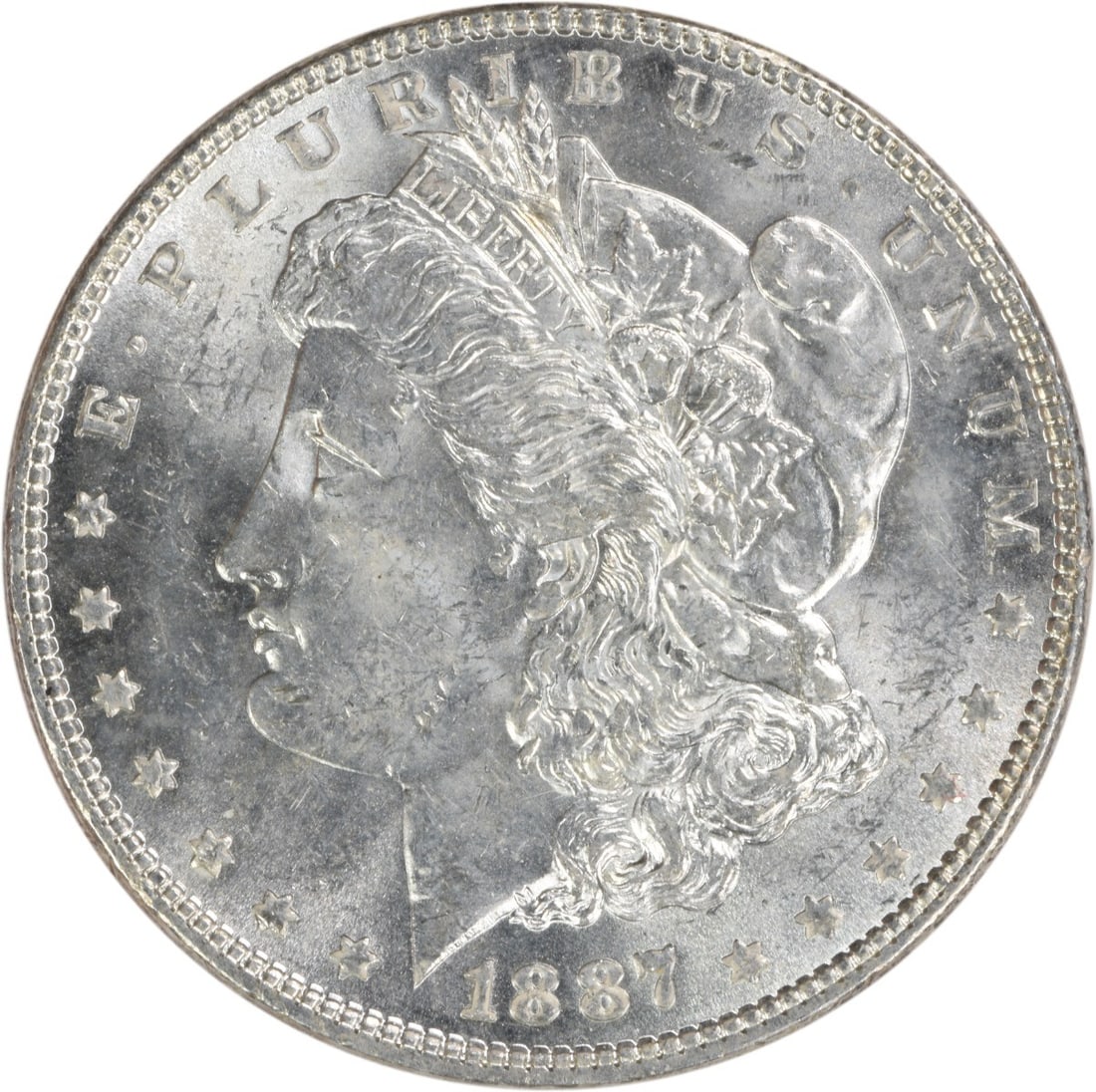 Choice BU 1887 Morgan Silver Dollar Uncirculated Uncertified US Coin: Choice BU 1887 Morgan Silver Dollar Uncirculated Uncertified US Coin This is an 1887 Morgan Silver Dollar from the United States, featuring a Choice Brilliant Uncirculated (BU) grade. The coin is comp