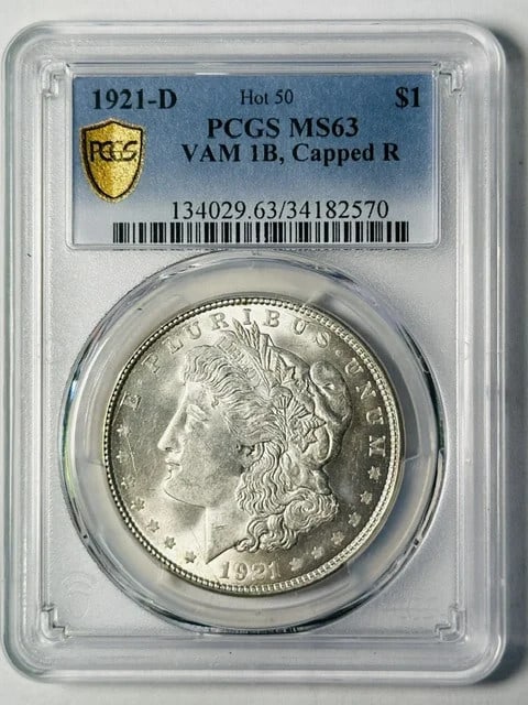 1921 Morgan Dollar PCGS MS63 VAM 1B Capped R: 1921 Morgan Dollar PCGS MS63 VAM 1B Capped R This 1921 D Morgan Silver Dollar is graded MS-63 by PCGS and features the VAM 1B Capped R variety. Minted in Denver, it is composed of silver and has been 
