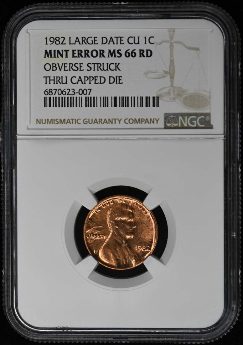 1982 Lincoln Cent NGC66RD Struck Thru Capped Die Mint Error: 1982 Lincoln Cent NGC66RD Struck Thru Capped Die Mint Error This 1982 Lincoln Cent features a rare mint error known as a 'Struck Thru Capped Die'. Certified by NGC with a grade of MS66, this coin show