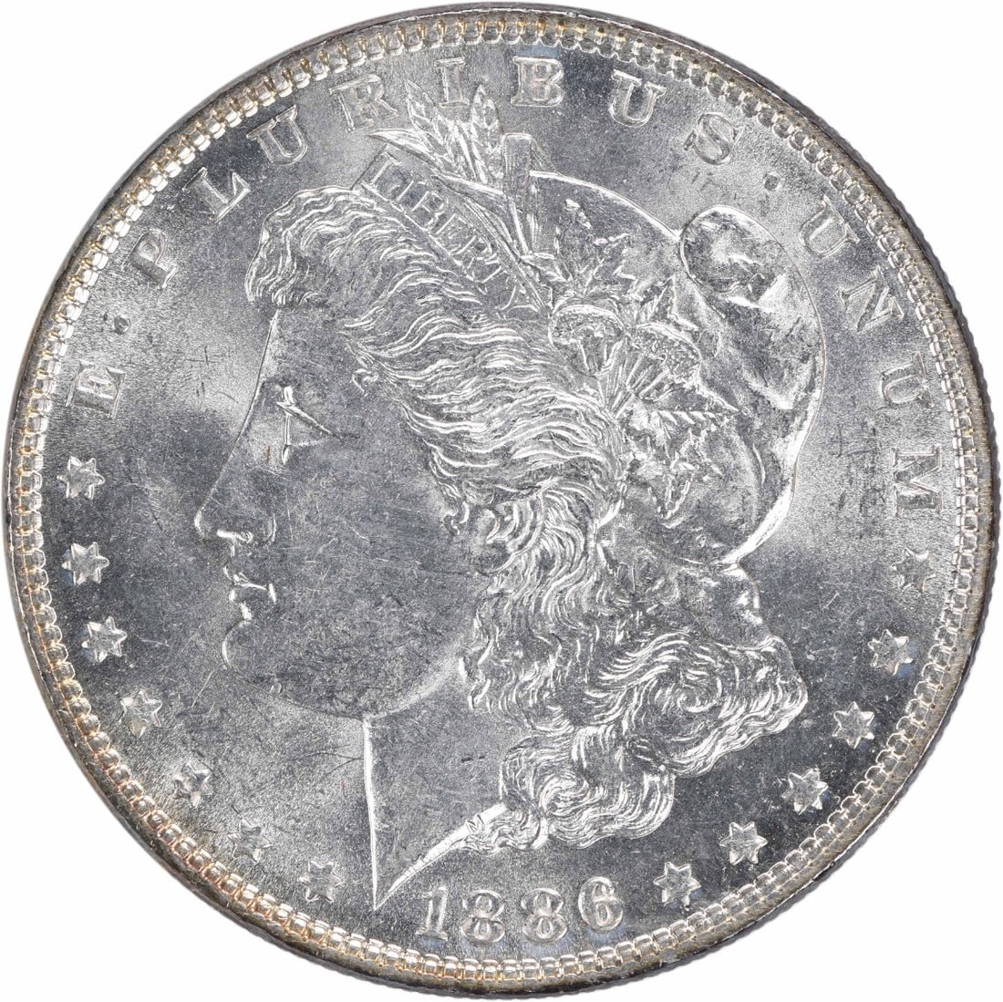 Toned 1886 Morgan Dollar Silver Coin Choice BU Uncertified: Toned 1886 Morgan Dollar Silver Coin Choice BU Uncertified This 1886 Morgan Silver Dollar is a Choice Brilliant Uncirculated (BU) coin, featuring attractive toning. It is uncertified and does not have
