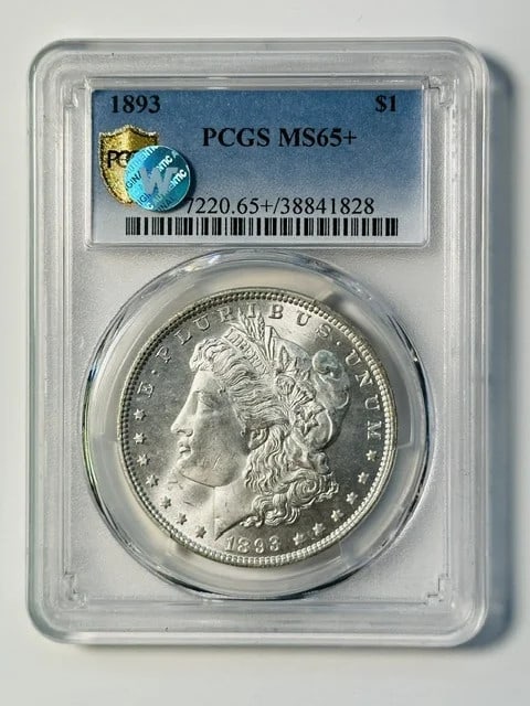 PCGS MS-65+ 1893 Morgan Silver Dollar Philadelphia: PCGS MS-65+ 1893 Morgan Silver Dollar Philadelphia 1893 Morgan Silver Dollar certified by PCGS and graded MS 65+. This pre-owned U.S. dollar coin is composed of silver and was minted in Philadelphia. 