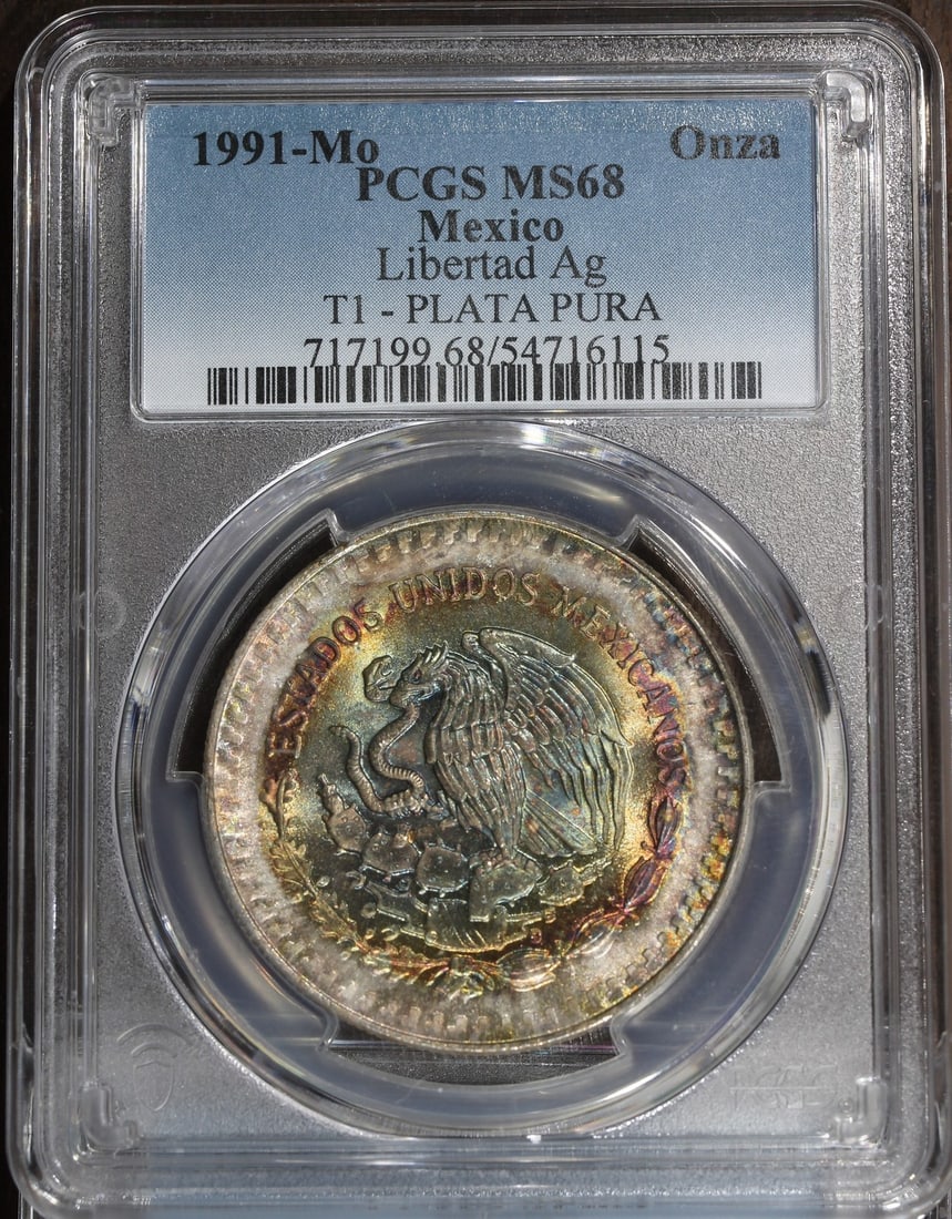 PCGS MS68 1991-Mo Mexico Silver Libertad Onza 1 oz Rainbow Reverse: PCGS MS68 1991-Mo Mexico Silver Libertad Onza 1 oz Rainbow Reverse 1991 Mexico 1 oz Silver Libertad Onza coin certified by PCGS and graded MS 68. It is composed of 0.999 fine silver and is listed as p