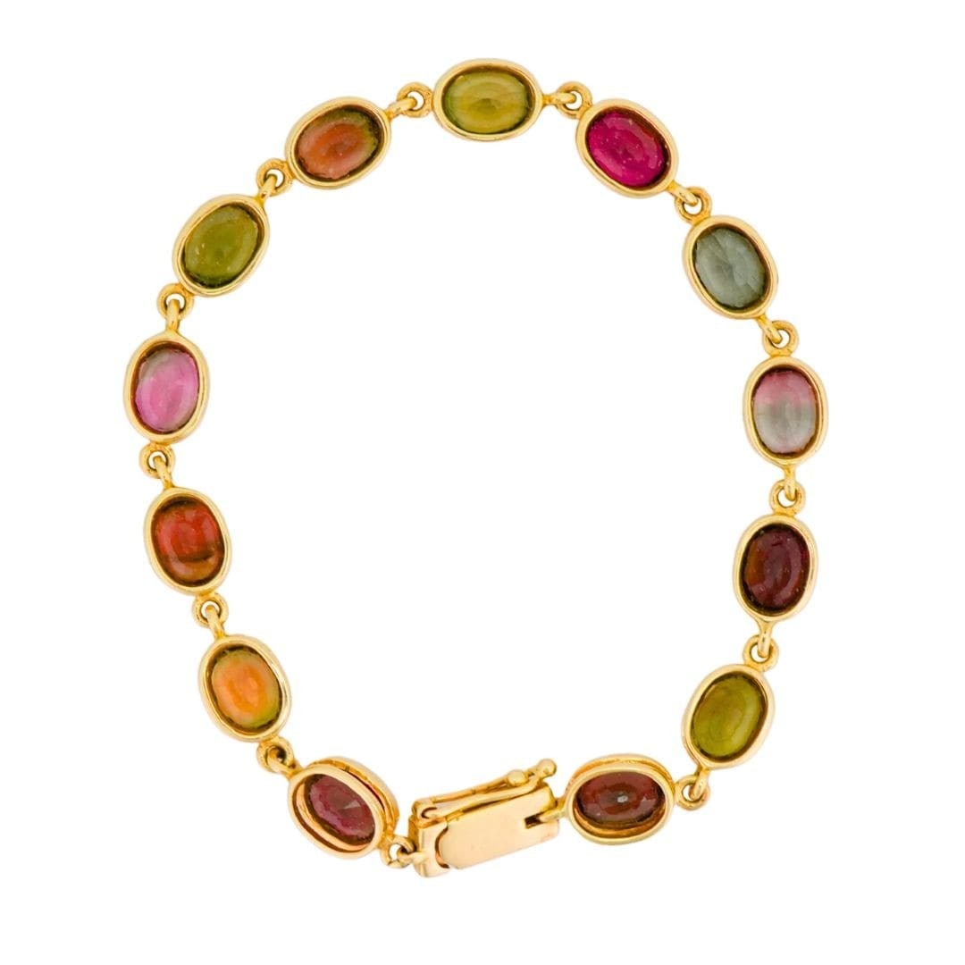 14K Yellow Gold Tennis Bracelet with 13 Gemstones: 14K Yellow Gold Tennis Bracelet with 13 Gemstones This 14K yellow gold tennis bracelet features a vibrant array of natural gemstones, including mixed garnets, peridot, and tourmaline. The bracelet is 