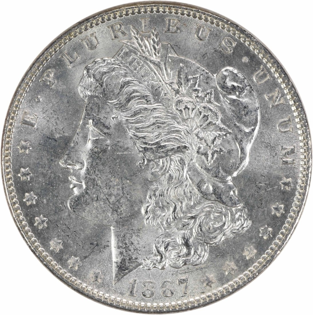 1887 Morgan Dollar Silver Choice BU Uncertified: 1887 Morgan Dollar Silver Choice BU Uncertified This is an 1887 Morgan Silver Dollar from the United States, featuring a Choice Brilliant Uncirculated (BU) grade. The coin is composed of silver and is