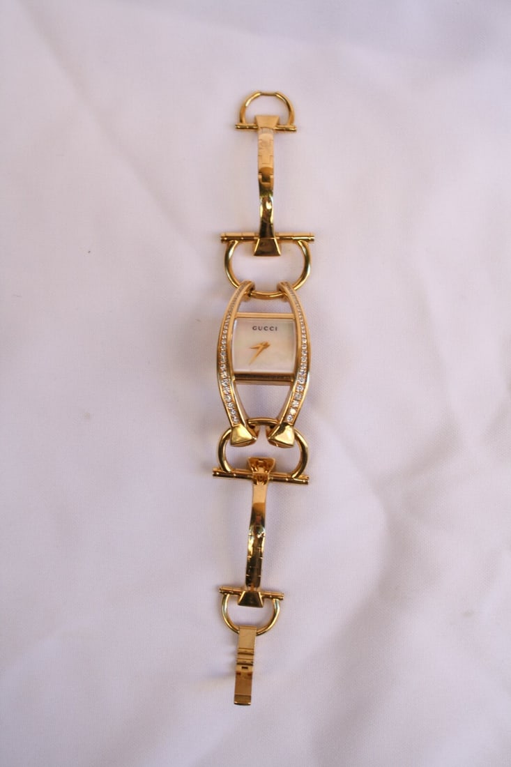 Gucci 18K Gold Diamond Mother of Pearl Watch with Box: Gucci 18K Gold Diamond Mother of Pearl Watch with Box This exquisite Gucci watch is a stunning combination of luxury and craftsmanship. Made from 18K gold, it features a beautiful mother of pearl dial