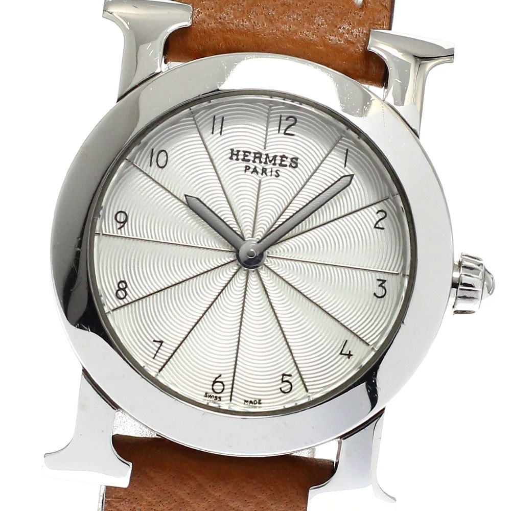 Hermes H-Watch Ronde Quartz Stainless Steel Ladies Watch HR1.210: Hermes H-Watch Ronde Quartz Stainless Steel Ladies Watch HR1.210 This Hermes H-Watch Ronde women's wristwatch features a stainless steel case paired with a leather strap. The watch is powered by a qua