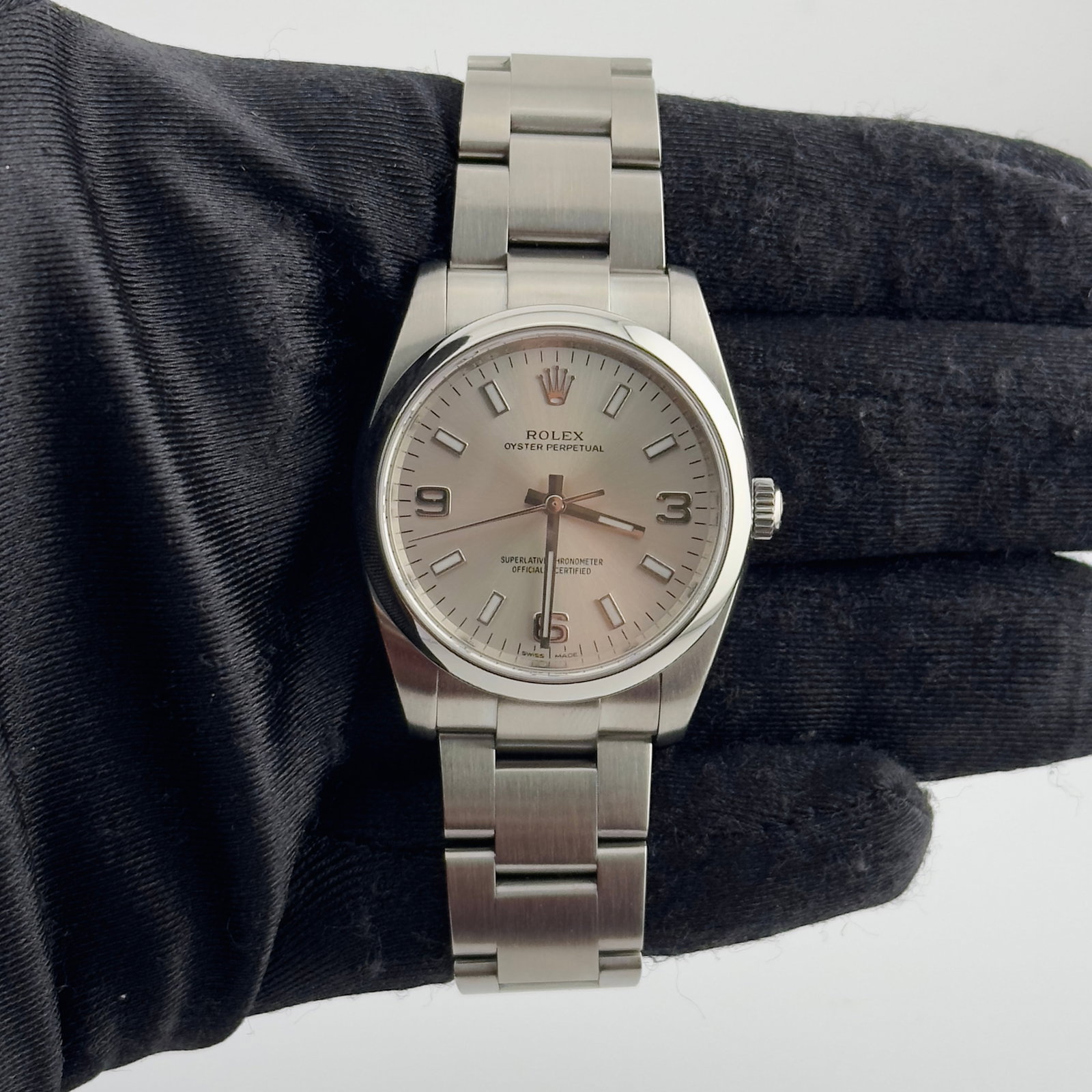 Rolex Oyster Perpetual Ref 114200 Unisex Watch with Silver Dial and Oyster Bracelet: Rolex Oyster Perpetual Ref 114200 Unisex Watch with Silver Dial and Oyster Bracelet This Rolex Oyster Perpetual features a silver dial with a smooth bezel and is fitted with the classic Oyster bracele